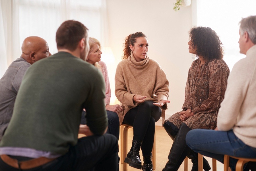 woman speaking in group therapy