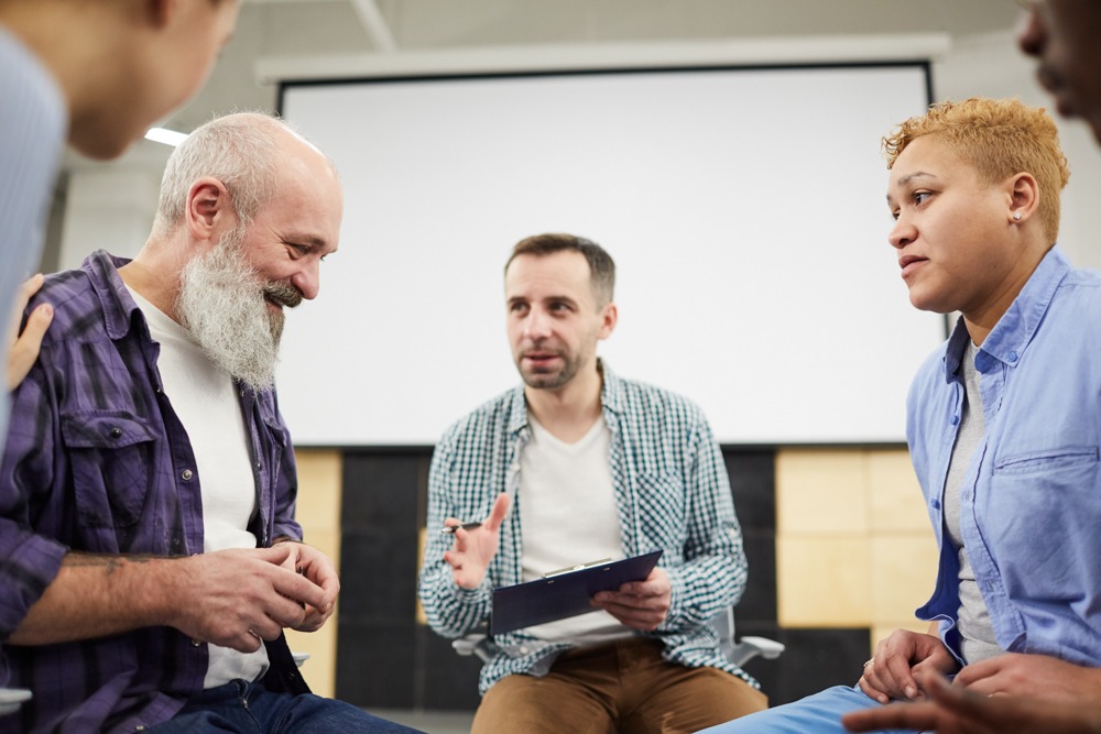 Therapist leading a group discussion in a residential treatment center for recovery