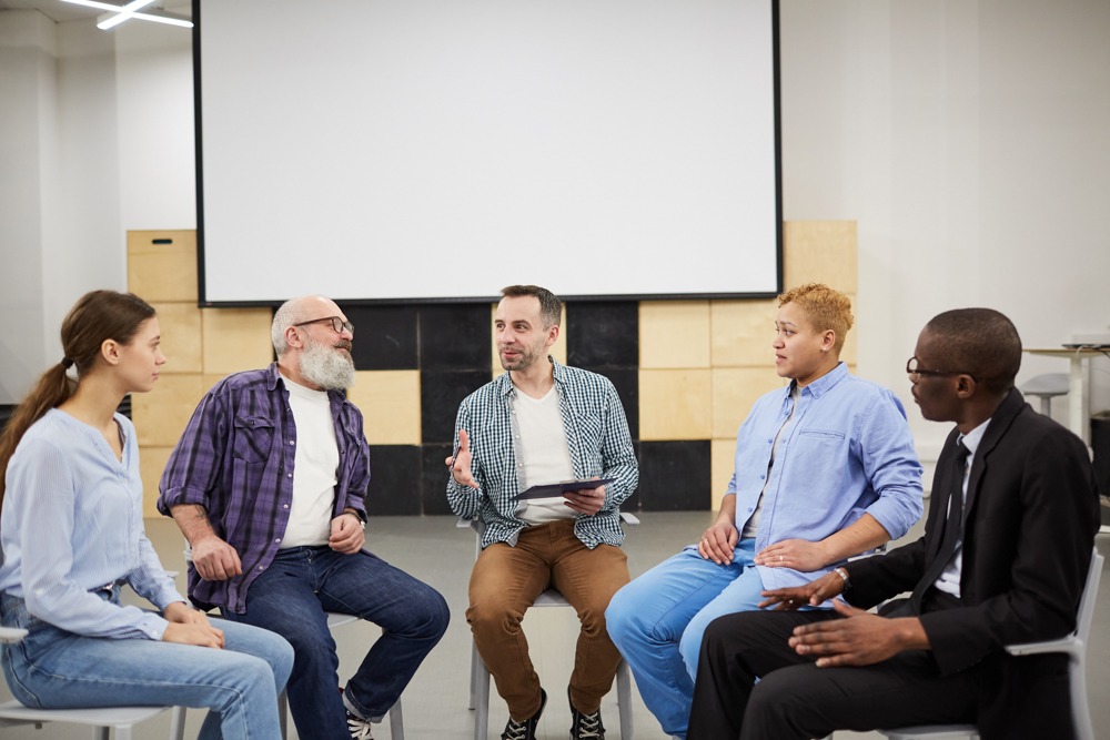 Diverse group engaging in a therapy session at a residential treatment center