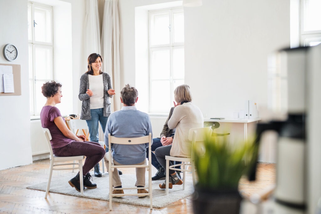 a woman speaking in group therapy