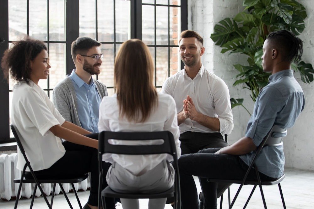 individuals-smiling-in-group-therapy